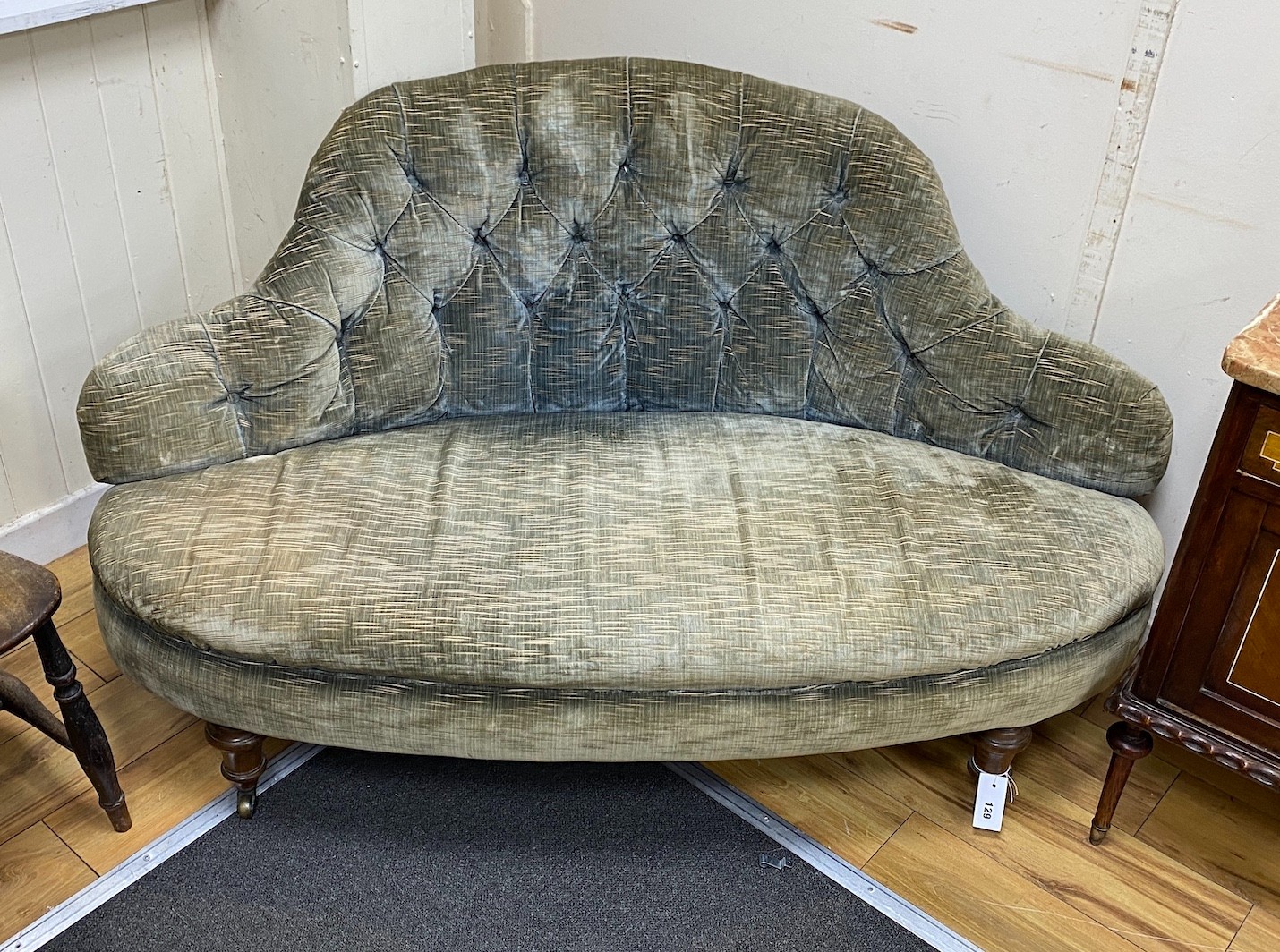 A Victorian upholstered settee with deep buttoned back, length 140cm, depth 56cm, height 77cm